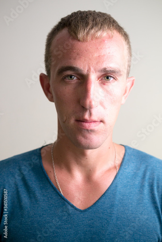 Face of man with blond hair looking at camera