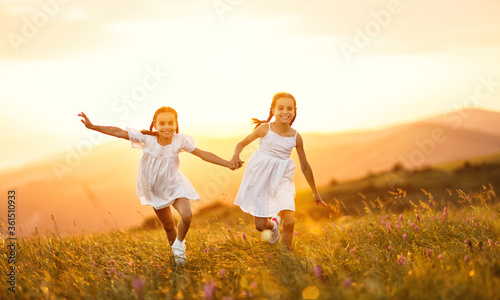 happy children run in nature in summer.