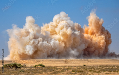 Dust storm and flying rock particle in the desert during detonator blast 