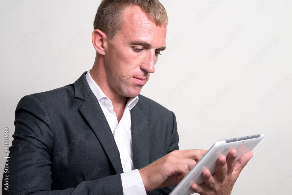Face of businessman in suit using digital tablet Face of businessman in suit using digital tablet