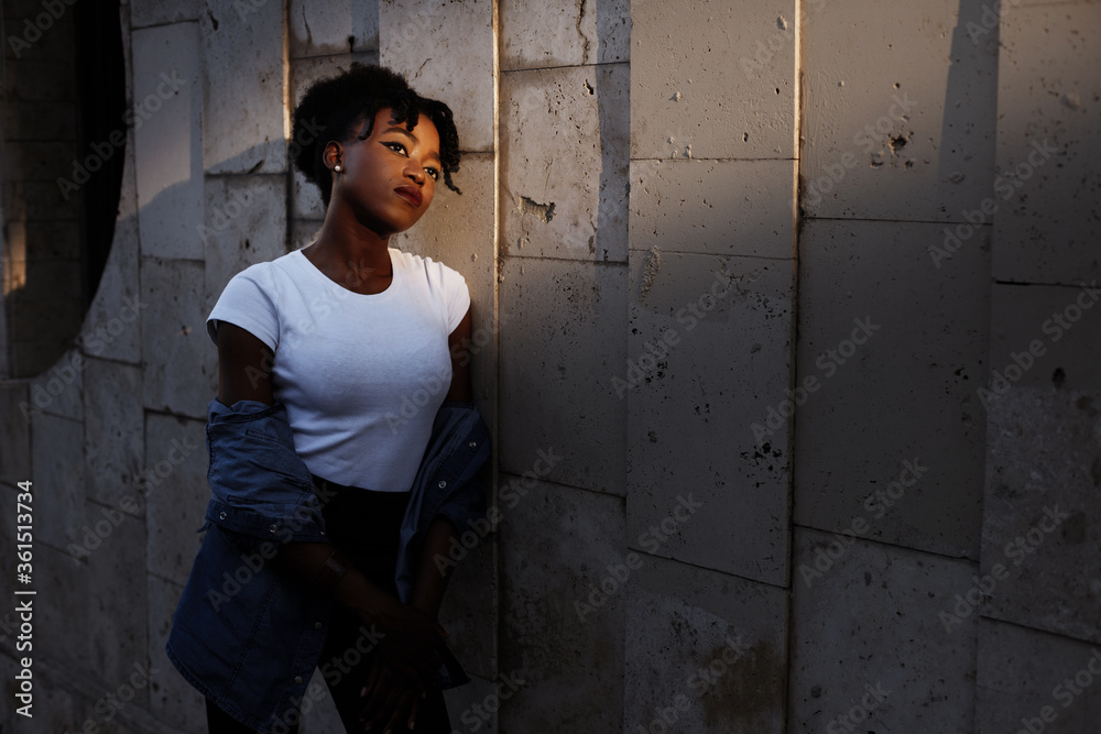portrait of a dark-skinned girl in the sun in the city
