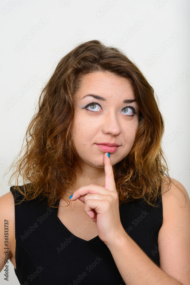 Face of young beautiful woman thinking and looking up Face of young beautiful woman thinking and looking up