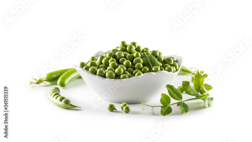 Green raw peas in pocelain bow isolated on white background photo