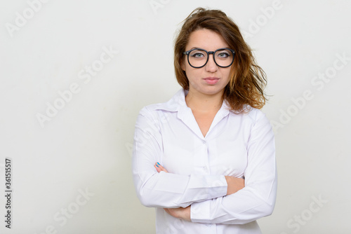 Portrait of young beautiful businesswoman wearing eyeglasses with arms crossed