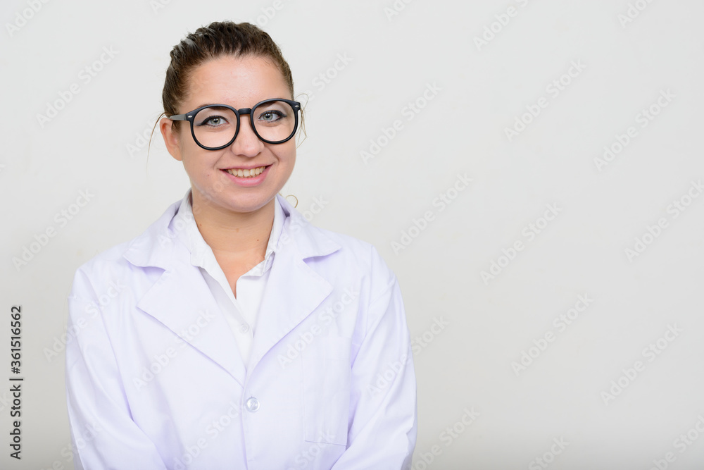 Portrait of happy young beautiful woman doctor with eyeglasses smiling