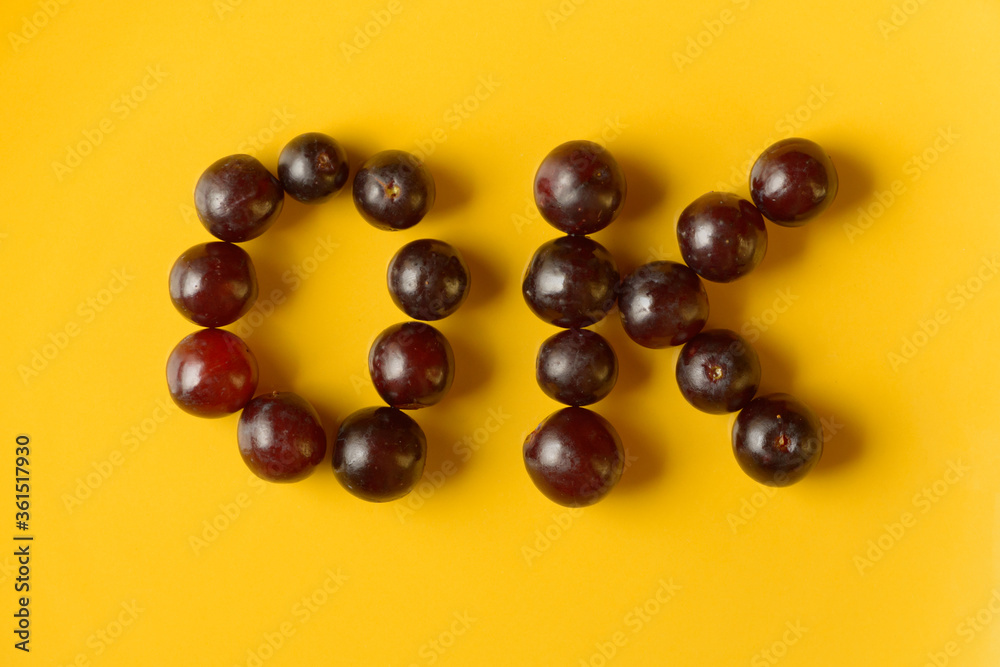 Portrait of OK sign made of grapes Portrait of OK sign made of grapes