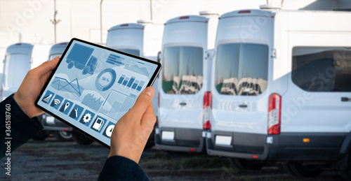 Manager with a digital tablet on the background of trucks. Fleet management