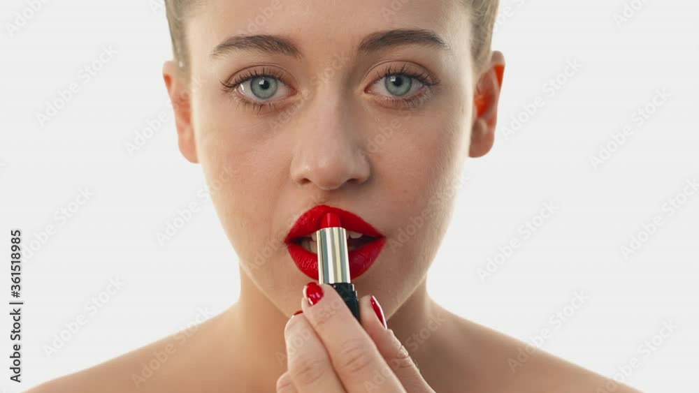 Woman paints lips with luxury cosmetics. Matching the shade of suitable
