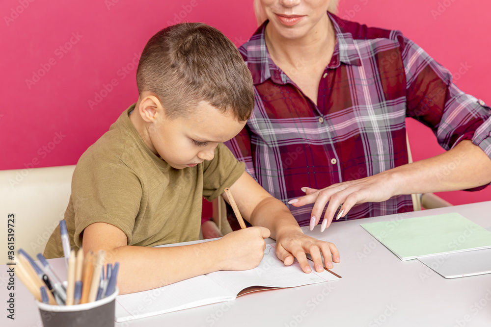 Mother with son at home doing homework together in quarantine time Mother with son at home doing homework together in quarantine time