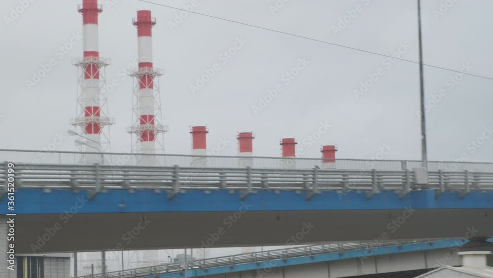 Industrial view from train window. Pipes of the thermal power plant. Pollution of the environment. Industrial view from train window. Pipes of the thermal power plant. Pollution of the environment.