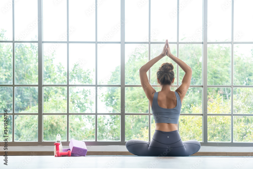 Close up of woman performing yoga child pose with equipment for practice yoga Close up of woman performing yoga child pose with equipment for practice yoga