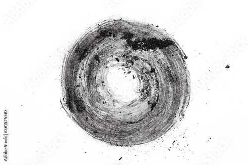 Activated charcoal powder for facial mask, skin care and beauty, black charcoal dust circle on white background photo