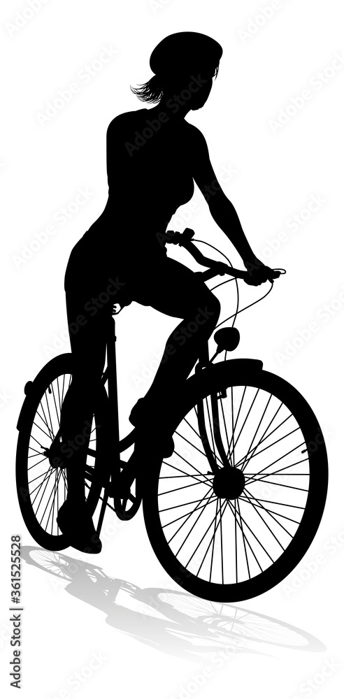 Obraz premium Bicyclist riding their bike and wearing a safety helmet in silhouette