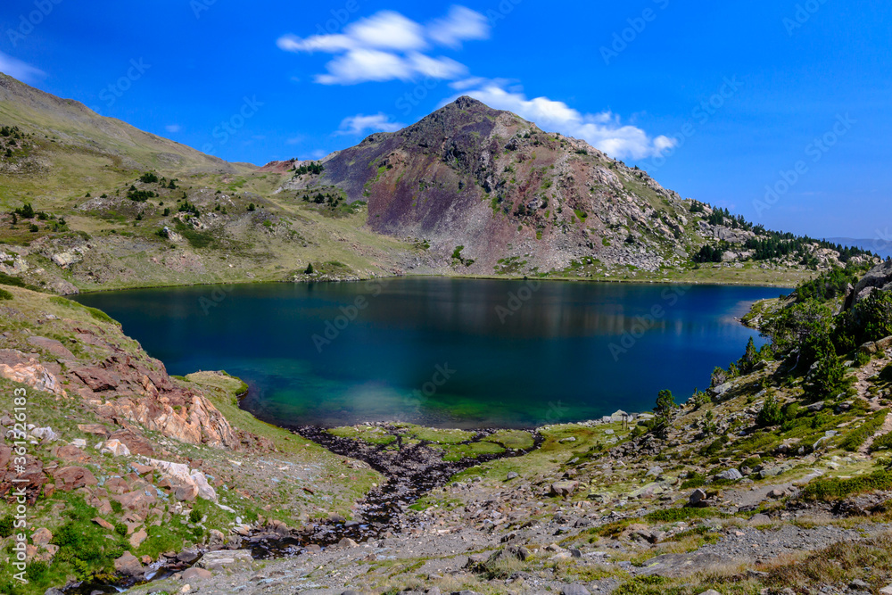 Blue water lake in the Pyrenees Mountains. (Capcir, France, the route of the Carlit Lakes, near the Massif of Carlit) Blue water lake in the Pyrenees Mountains. (Capcir, France, the route of the Carlit Lakes, near the Massif of Carlit)