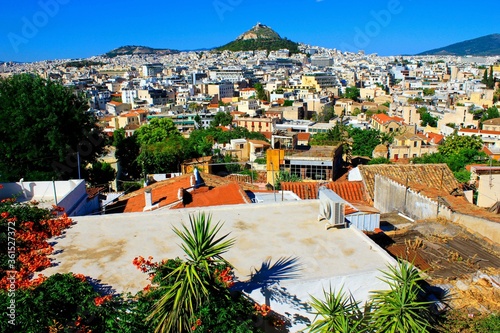 Greece, Athens, June 16 2020 - Athens city view from the area of Anafiotika in Plaka district with Lycabetus hill in the background. photo