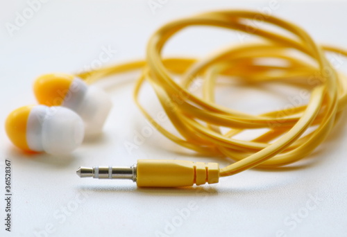 Stereo yellow headphones, close-up on a white background, 1 meter