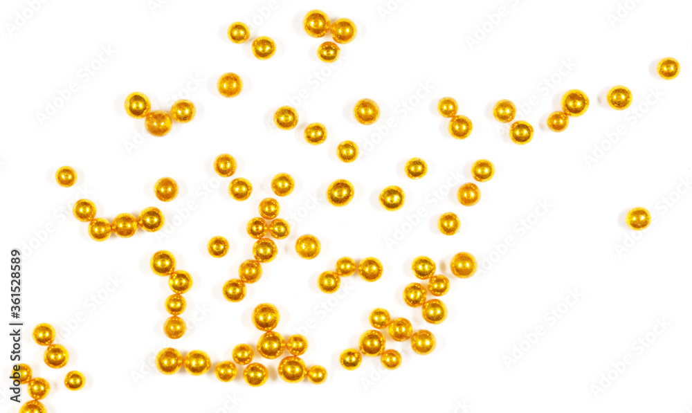 Small balls of gold on a white background.