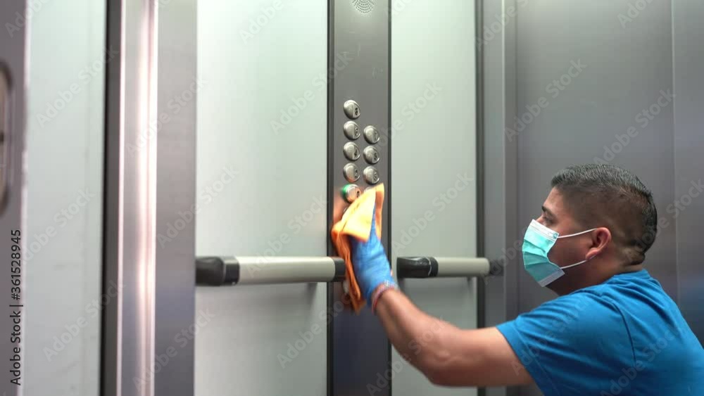 Cleaning professional thoroughly disinfecting elevator push buttons