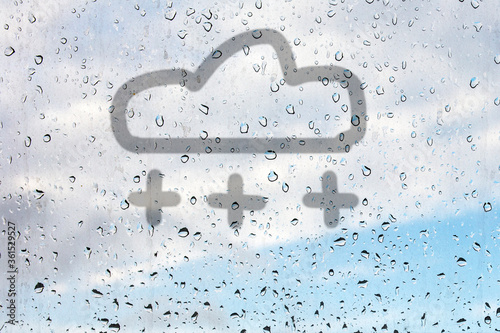 Canvas Print The drawing of snow shower symbol drawn by a finger on the misted glass