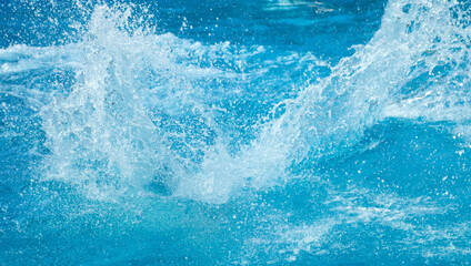 Blue water splash in the pool
