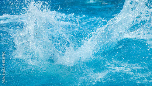Blue water splash in the pool photo