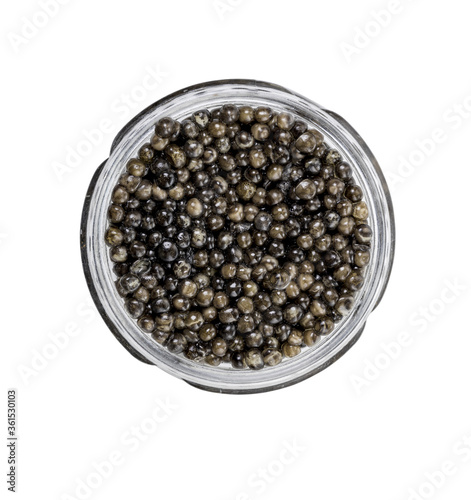 Glass jar with natural, delicious black caviar, isolated on white background.