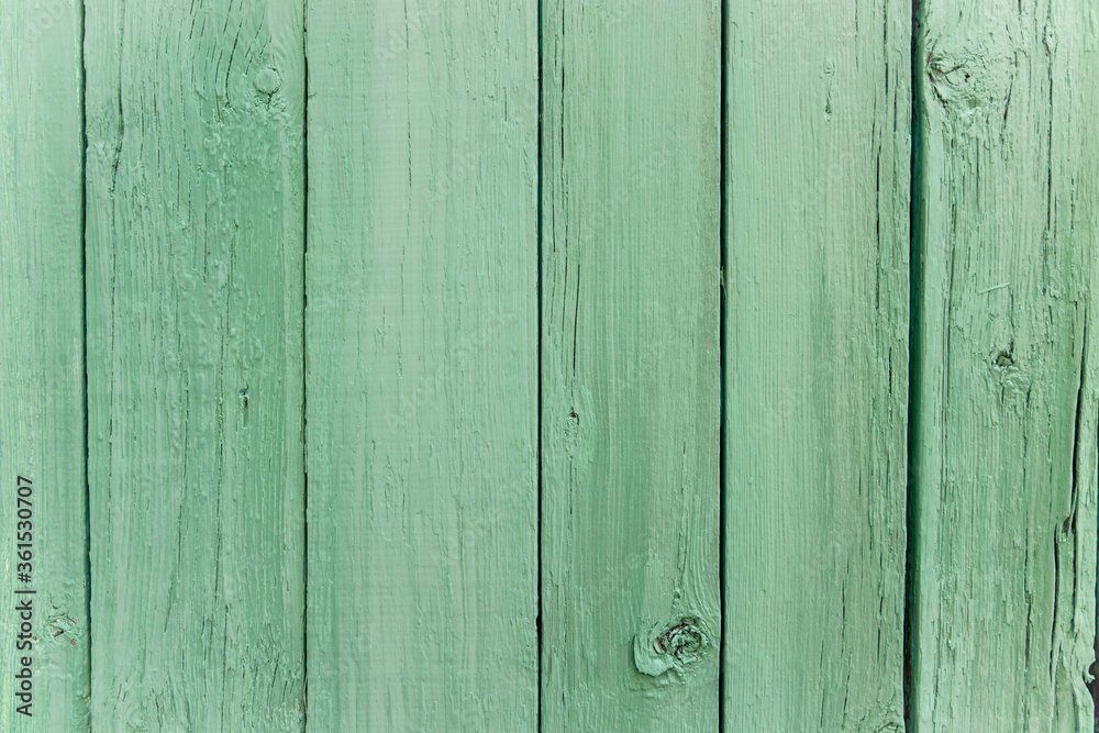 Fototapeta premium Wooden vertical striped desk painting mint pastel color. Texture