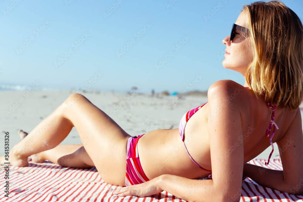 Beautiful woman sunbathing on the beach