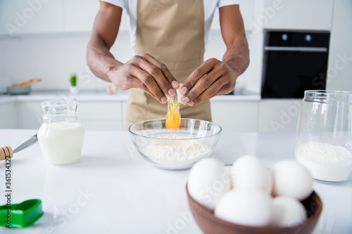 Cropped view of his he nice attractive guy good confectioner making fresh bread egg pie national culinary confectionery meal dish holiday day in modern light white interior house kitchen