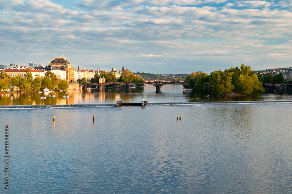 Obraz premium Distant view of National museum, Strelecky island and the riverbank of Vltava from the middle of Charles bridge