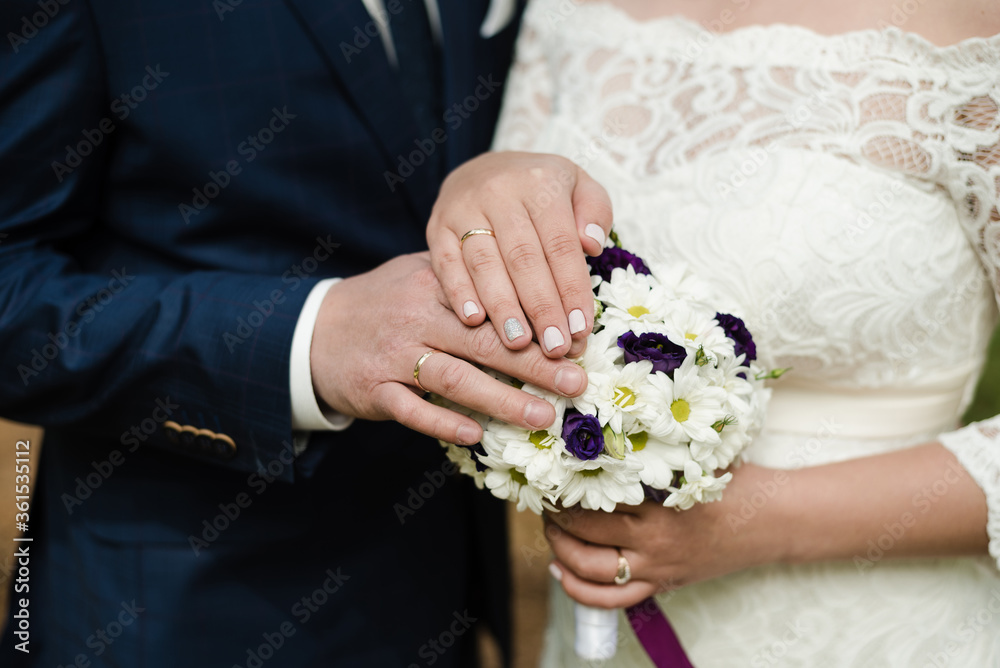 wedding day, hands with wedding rings, wedding rings, bride and groom, the bride's bouquet wedding day, hands with wedding rings, wedding rings, bride and groom, the bride's bouquet