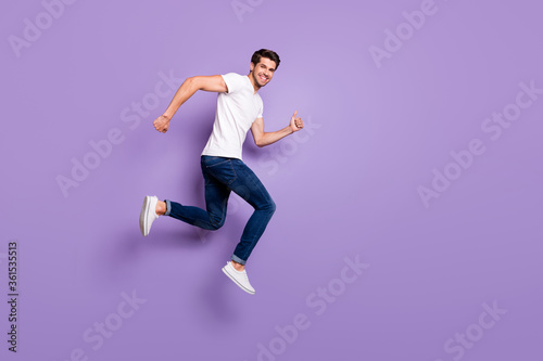 Full length body size view of his he nice attractive cheerful cheery sportive guy jumping running distance isolated on bright vivid shine vibrant violet lilac purple color background