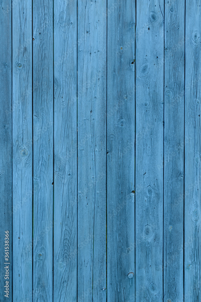 Fototapeta premium Blue wooden background, old age effect. Old boards painted light blue, close-up. Vertical image.