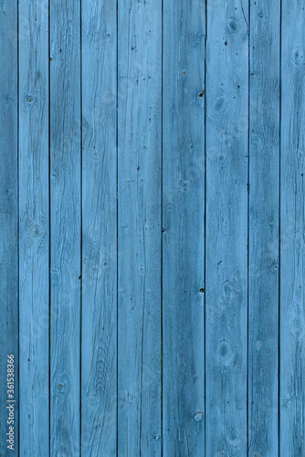 Blue wooden background, old age effect. Old boards painted light blue, close-up. Vertical image.