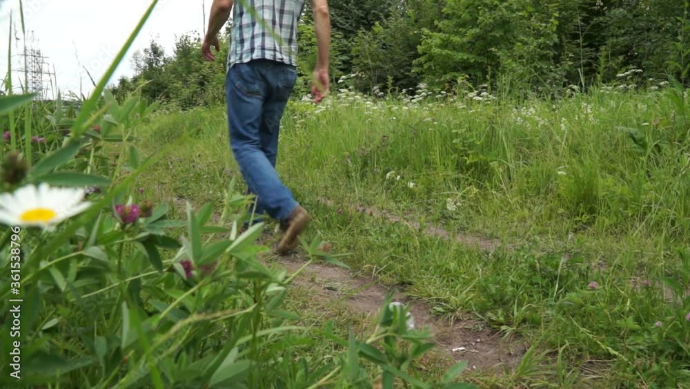 a man throws a plastic bottle in the woods. Environmental pollution a man throws a plastic bottle in the woods. Environmental pollution