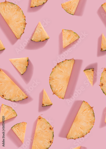 Seamless pineapple slices pattern on pink background