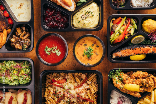 group of food in plastic dish on table. take away food