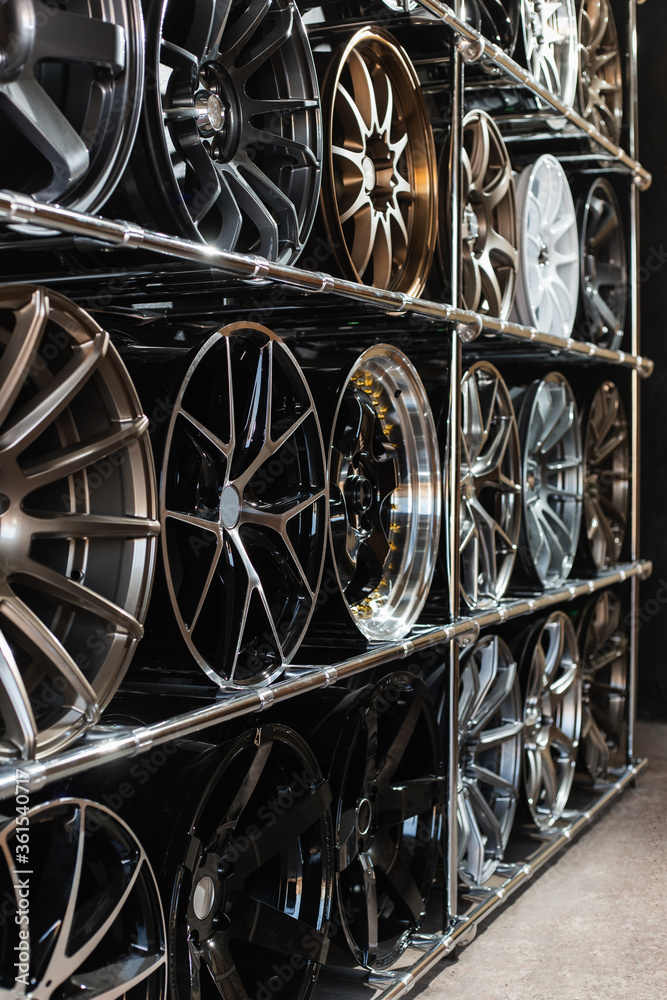 Stand with alloy wheels in modern tire store. Stand with alloy wheels in modern tire store.