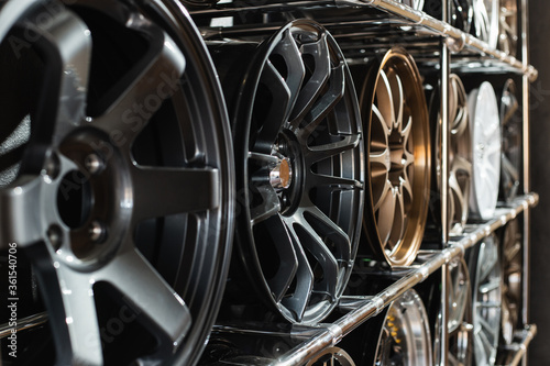 Tableau sur toile Stand with alloy wheels in modern tire store.