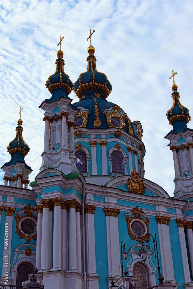 Astonishing detailed view of ancient Saint Andrew Church against blue sky at sunny spring morning. Baroque style in ancient architecture. Architectural icon of the city of Kyiv, Ukraine