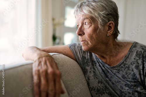 Portrait Of Senior Woman On Sofa Suffering From Depression