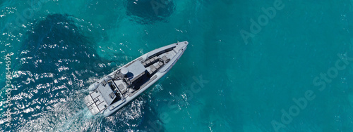 Aerial drone ultra wide photo of inflatable rigid speed boat cruising open ocean deep blue sea © aerial-drone