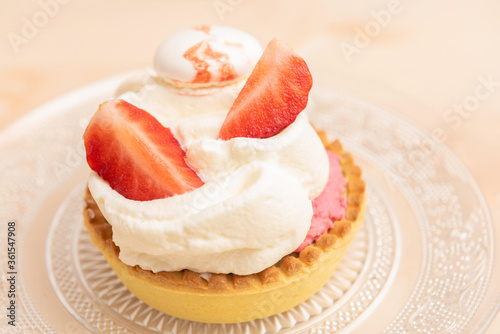 Homemade tarts with custard cream, white meringue and strawberry