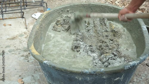 Top view worker mixing the cement with sand in the big wagon