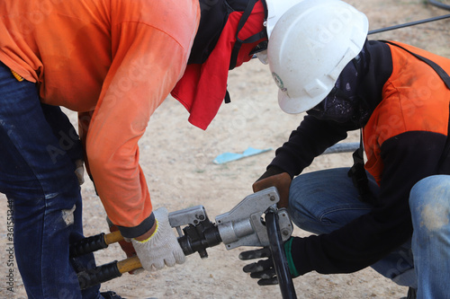 Konstfotografi The electrician is connecting the high voltage cables together.