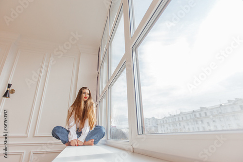 Free Download beautiful girl sitting on the window and smiling - GFXLoad