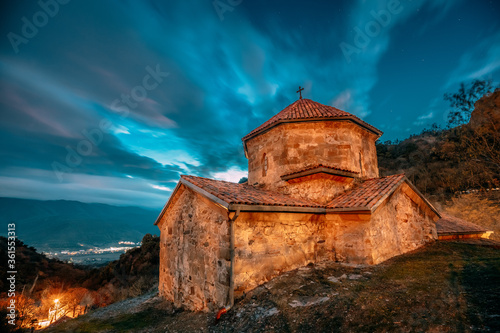 Mtskheta, Georgia. Shio-mgvime Monastery. Church Of Holy Virgin Or Theotokos In Medieval Monastic Shiomgvime Complex In Limestone Canyon Under Autumn Night Sky photo