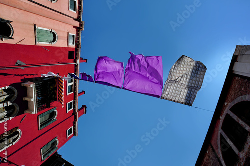 Sheets waving, spread between two buildings photo