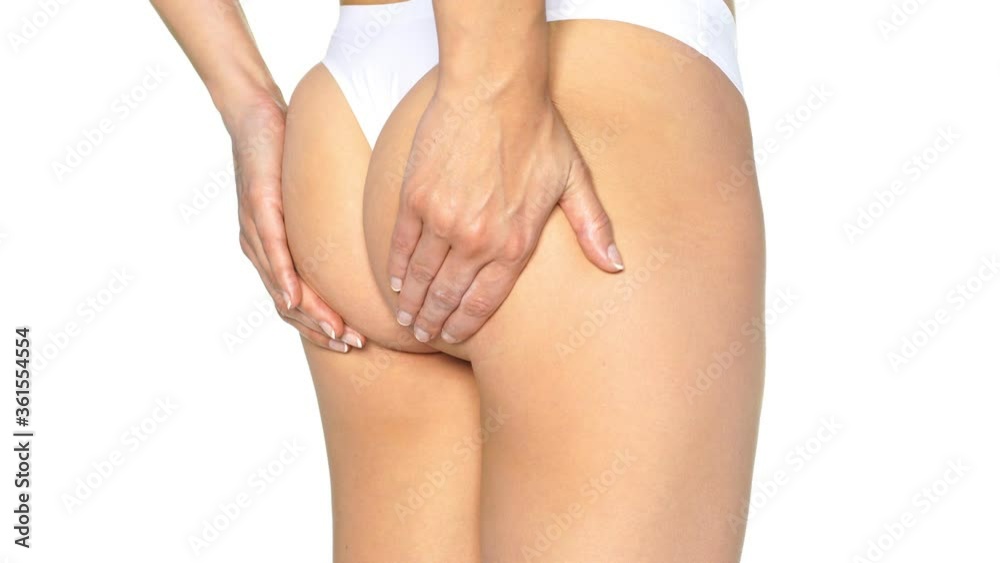 young woman lift her buttocks with her hands on a white background young woman lift her buttocks with her hands on a white background