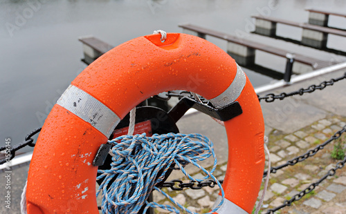 Orange rescue ring with launch roupe on a pier photo